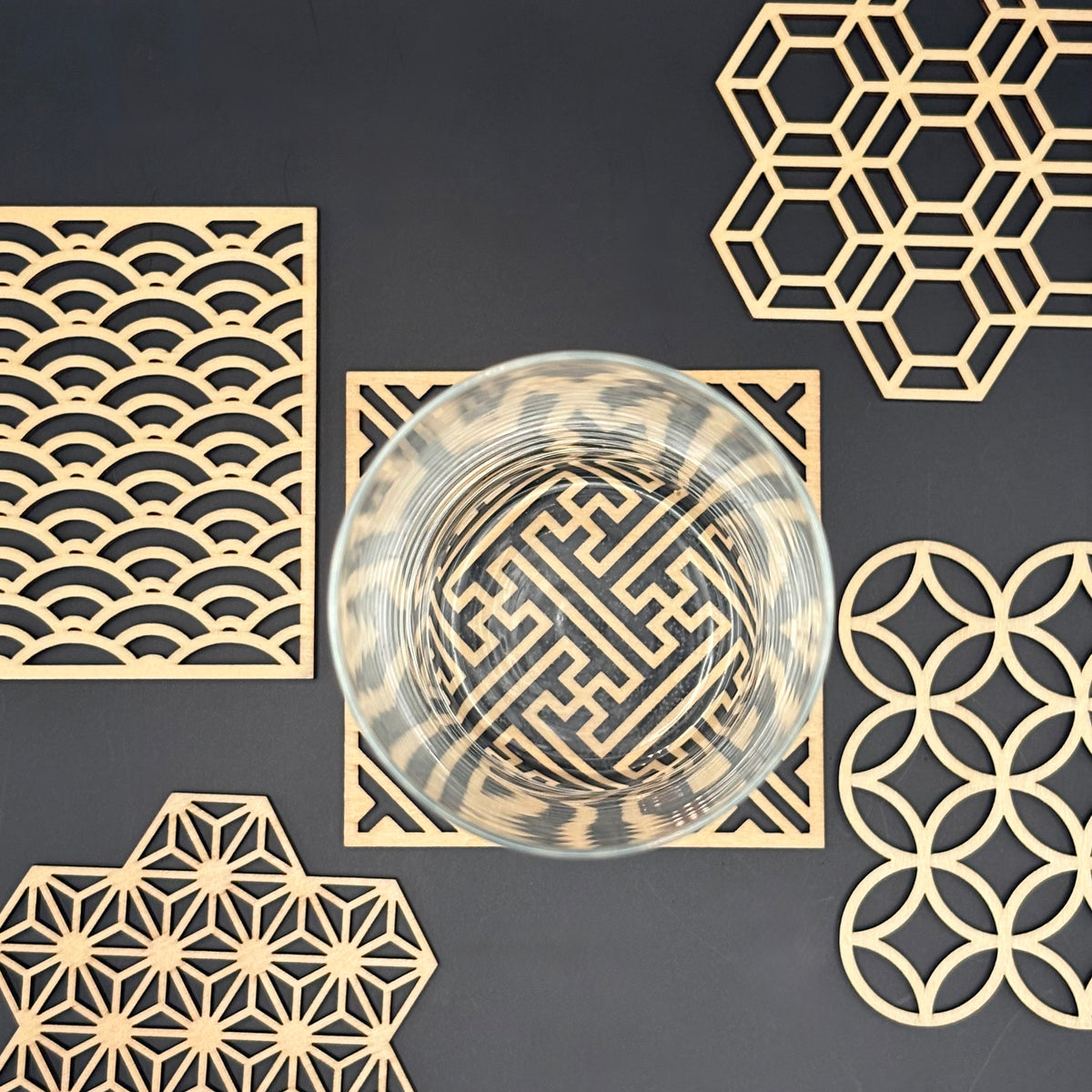 Five Blessings coaster in use, glass resting on the Shippou (interlocking circles) pattern
